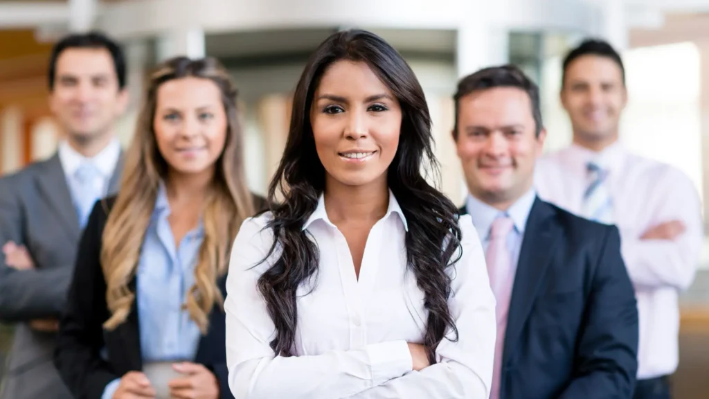 Women in White Standing in front of Corporate Team